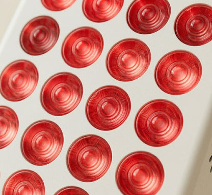 Pattern of red circular objects on a white background